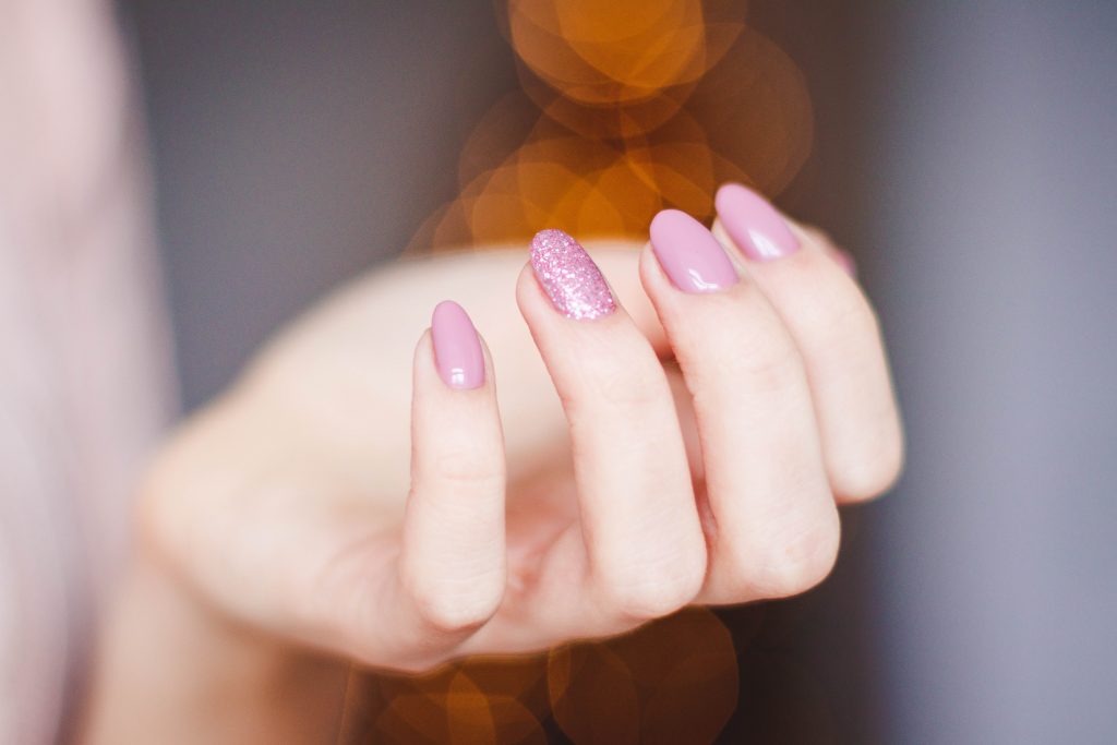 woman's hand with pink manicure