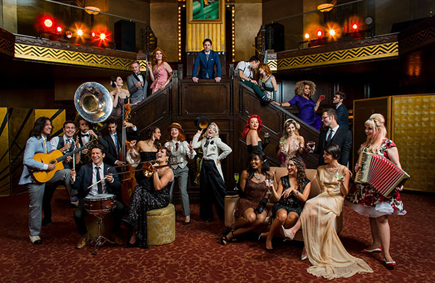 Postmodern Jukebox ensemble in period costumes with musical instruments